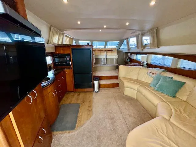 Why Knot Yacht Photos Pics Interior of 2003 Carver 410 Sport Sedan with cozy seating and modern amenities.