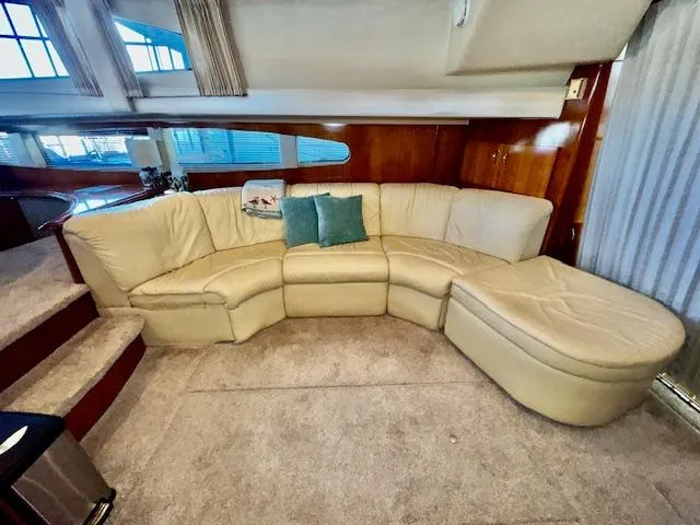 Why Knot Yacht Photos Pics Luxurious interior of 2003 Carver 410 Sport Sedan with cream leather sectional sofa.