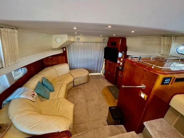 Why Knot Yacht Photos Pics Interior of 2003 Carver 410 Sport Sedan with beige leather seating and wood accents.