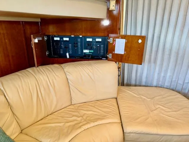 Why Knot Yacht Photos Pics 2003 Carver 410 Sport Sedan interior with beige leather seating and control panel.