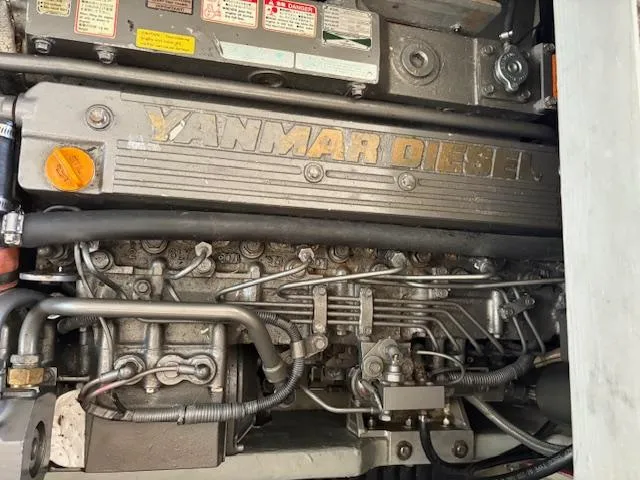 Figur'in It Out Yacht Photos Pics Yanmar diesel engine in a 2006 Mainship 400 Trawler, showcasing intricate mechanical components.