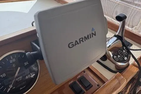 Figur'in It Out Yacht Photos Pics Garmin navigation system on 2006 Mainship 400 Trawler dashboard with controls and speedometer.