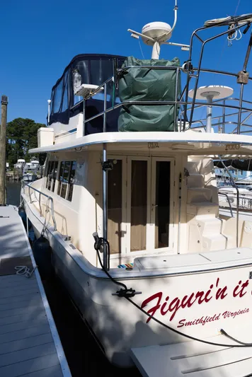 Figur'in It Out Yacht Photos Pics 2006 Mainship 400 Trawler docked, featuring upper deck and rear view.