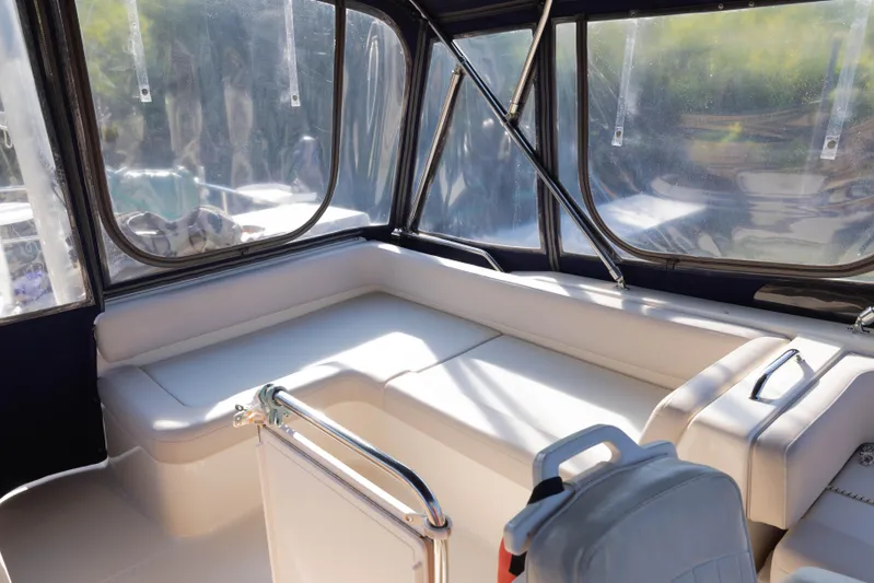 Figur'in It Out Yacht Photos Pics 2006 Mainship 400 Trawler interior with cushioned seating and clear windows.