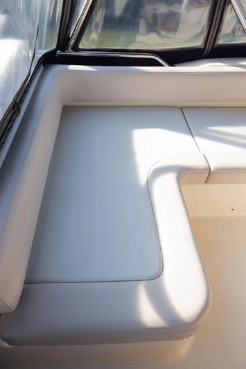 Figur'in It Out Yacht Photos Pics 2006 Mainship 400 Trawler interior with white cushioned seating.