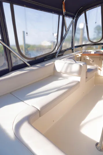 Figur'in It Out Yacht Photos Pics 2006 Mainship 400 Trawler interior with white seating and large windows.