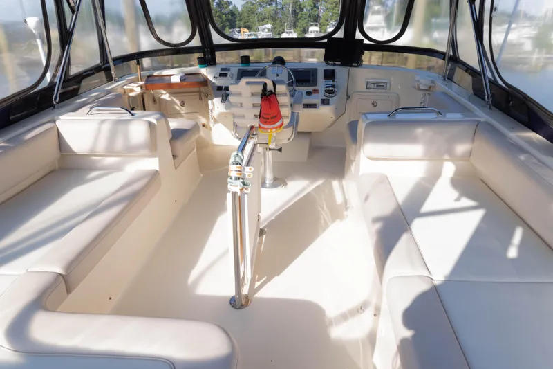 Figur'in It Out Yacht Photos Pics 2006 Mainship 400 Trawler interior with helm, seating, and navigation equipment.