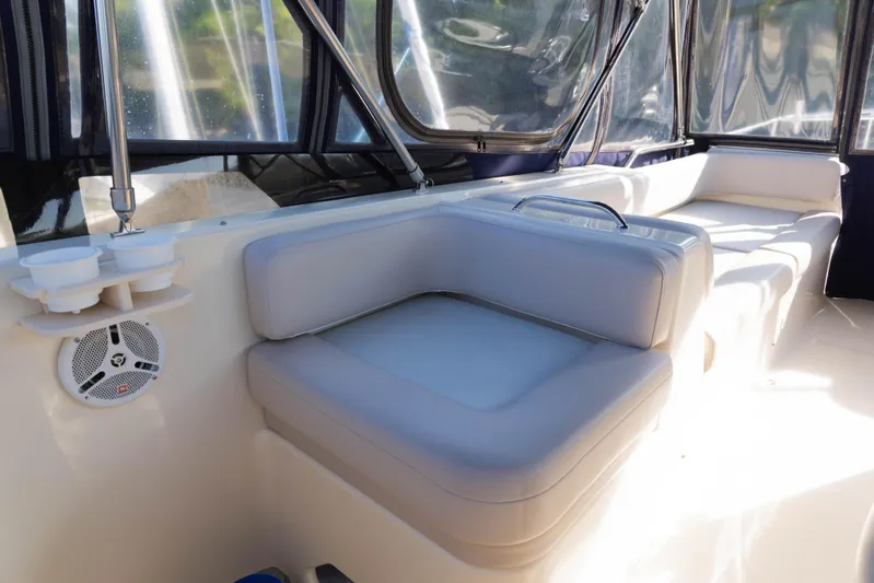 Figur'in It Out Yacht Photos Pics 2006 Mainship 400 Trawler interior with cushioned seating and clear windows.