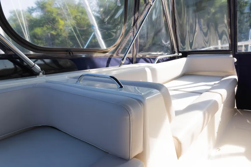 Figur'in It Out Yacht Photos Pics Interior seating of 2006 Mainship 400 Trawler with sunlight streaming through windows.