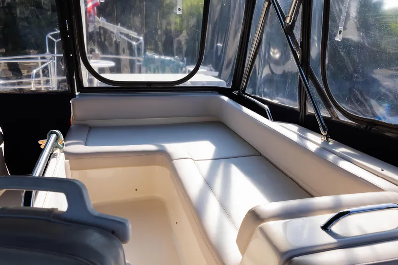 Figur'in It Out Yacht Photos Pics 2006 Mainship 400 Trawler interior with cushioned seating and clear windows.