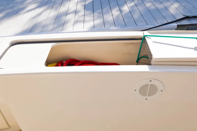 Figur'in It Out Yacht Photos Pics Storage compartment on 2006 Mainship 400 Trawler with red rope and speaker.