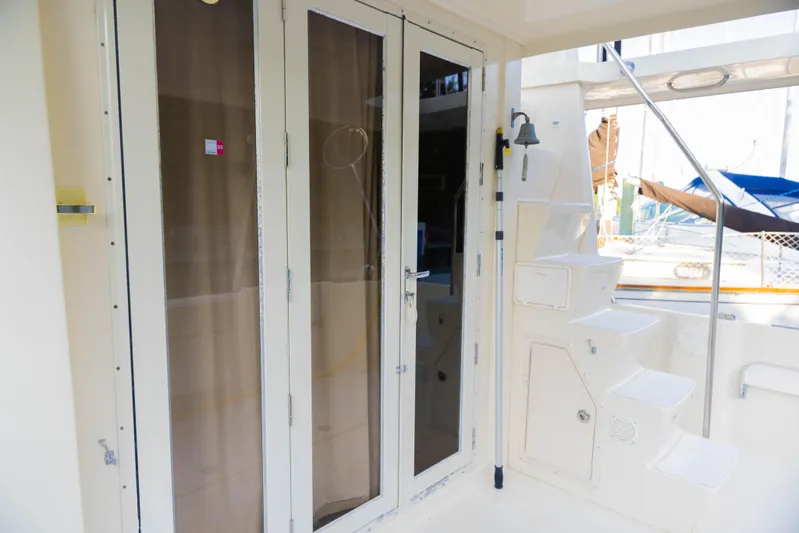 Figur'in It Out Yacht Photos Pics 2006 Mainship 400 Trawler exterior with glass doors and steps, showcasing nautical design.