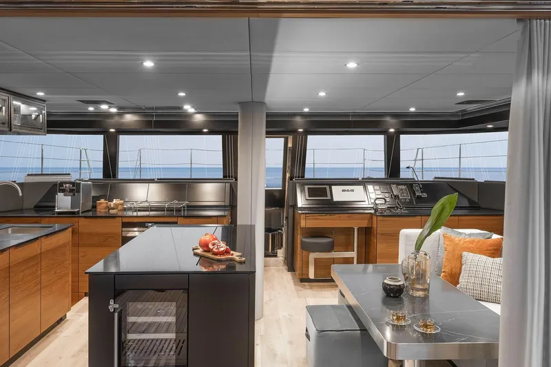  Yacht Photos Pics Luxurious interior of 2026 Sunreef 50 yacht with modern kitchen and dining area.