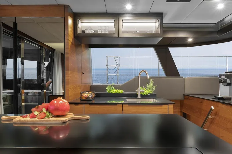  Yacht Photos Pics Luxurious Sunreef 50 yacht kitchen interior with ocean view, featuring modern design and fresh produce.
