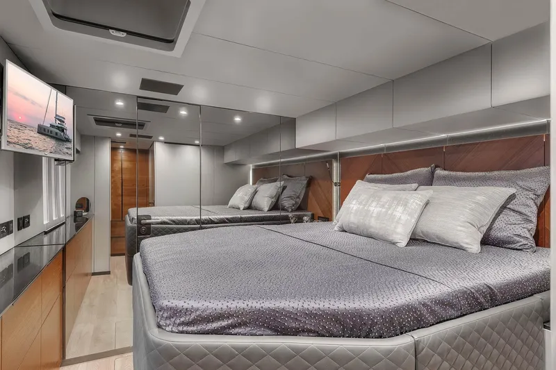  Yacht Photos Pics Luxurious bedroom interior of 2026 Sunreef 50 yacht with modern design and elegant bedding.