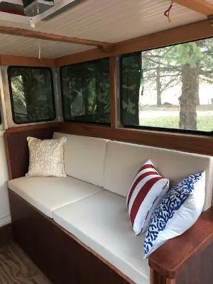  Yacht Photos Pics Interior of 2008 Gasparek Marine Eco Trawler with cushioned seating and decorative pillows.