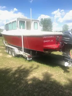  Yacht Photos Pics Red 2008 Custom Gasparek Marine Eco Trawler on trailer, Yamaha motor, sunny day.