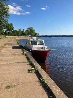  Yacht Photos Pics Custom Gasparek Marine Eco Trawler 2008 docked by a serene riverside walkway.