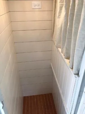  Yacht Photos Pics Small interior space with white shiplap walls and wooden floor on a 2008 Gasparek Marine Eco Trawler.