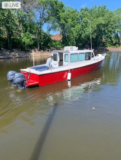  Yacht Photos Pics Red 2008 Gasparek Marine Eco Trawler on calm river, surrounded by trees.