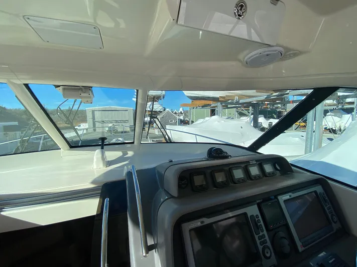  Yacht Photos Pics 2009 Pursuit OS 375 Offshore boat cockpit with navigation controls and clear windshield view.