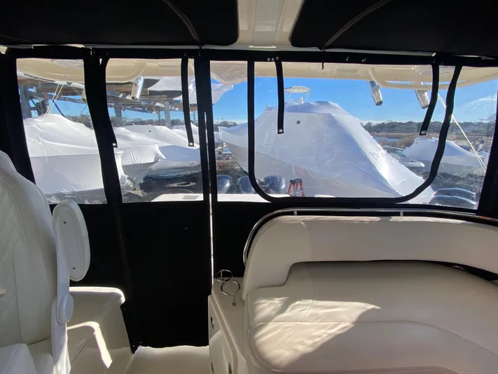  Yacht Photos Pics 2009 Pursuit OS 375 Offshore interior with white seating and clear windows.