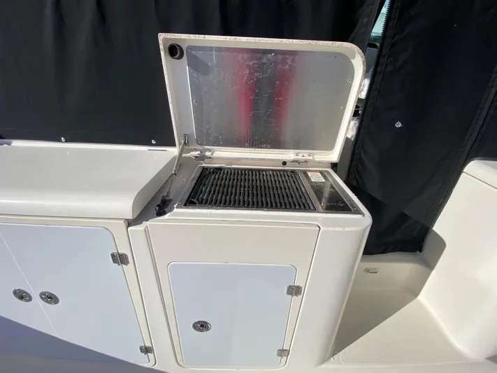  Yacht Photos Pics 2009 Pursuit OS 375 Offshore boat grill and storage compartments.