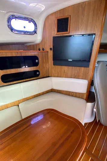  Yacht Photos Pics 2009 Pursuit OS 375 Offshore cabin with wood accents, TV, and seating area.