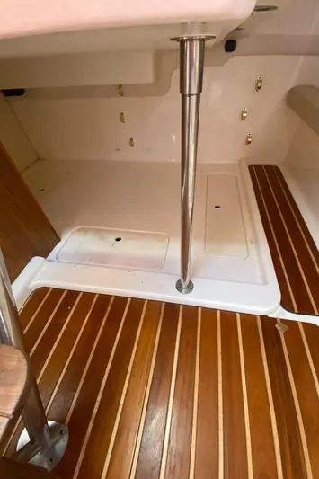  Yacht Photos Pics 2009 Pursuit OS 375 Offshore interior with wood flooring and metal fixtures.