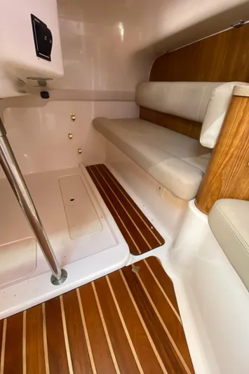  Yacht Photos Pics 2009 Pursuit OS 375 Offshore interior with wood flooring and cushioned seating.