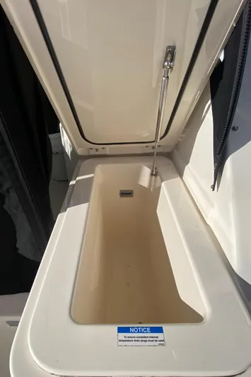  Yacht Photos Pics 2009 Pursuit OS 375 Offshore storage compartment with open hatch.