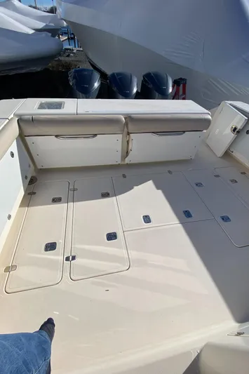  Yacht Photos Pics 2009 Pursuit OS 375 Offshore boat deck with storage compartments and seating.