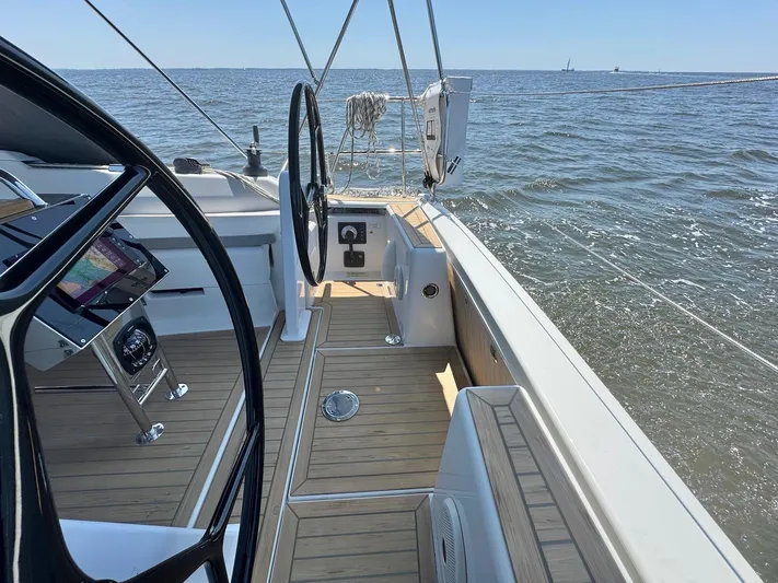 Ahyoka Yacht Photos Pics 2017 Hanse 345 sailboat cockpit with steering wheel, navigation system, and ocean view.