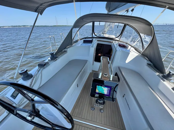 Ahyoka Yacht Photos Pics 2017 Hanse 345 sailboat cockpit with navigation system, steering wheel, and canopy on open water.