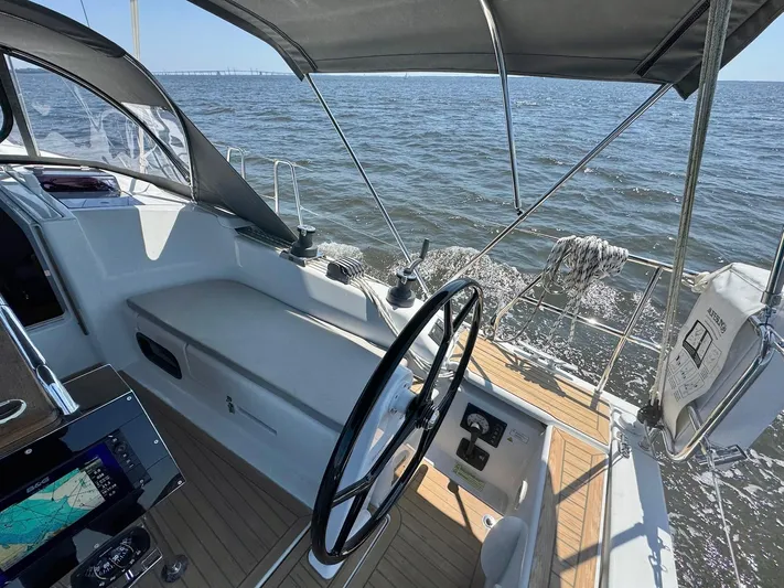 Ahyoka Yacht Photos Pics 2017 Hanse 345 sailboat cockpit with steering wheel, navigation equipment, and ocean view.