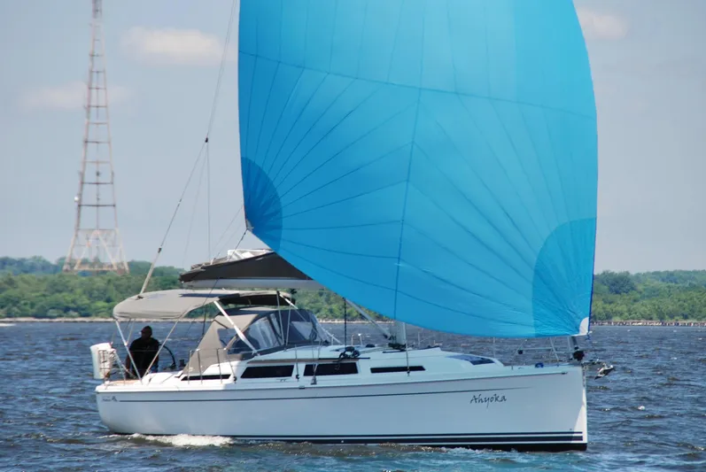 Ahyoka Yacht Photos Pics 2017 Hanse 345 sailboat with blue spinnaker sailing on open water.