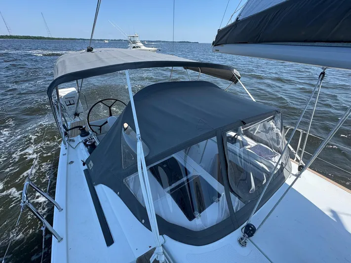 Ahyoka Yacht Photos Pics 2017 Hanse 345 sailboat with canopy, sailing on open water under clear skies.