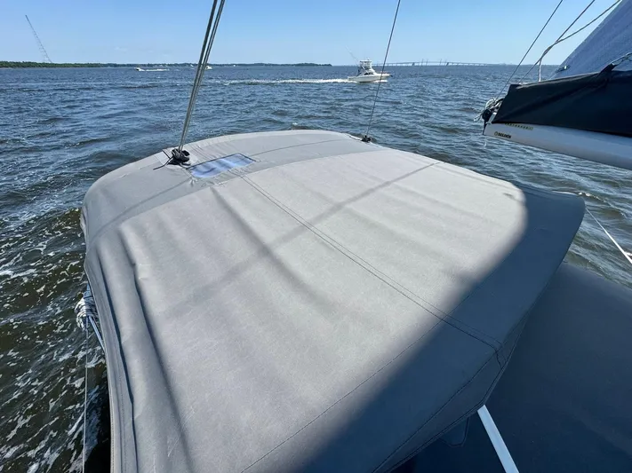 Ahyoka Yacht Photos Pics Sailing on a 2017 Hanse 345 yacht, calm waters, clear sky, distant boat visible.