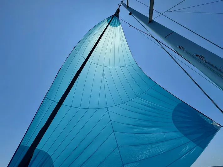 Ahyoka Yacht Photos Pics Blue sail of 2017 Hanse 345 yacht against clear sky.