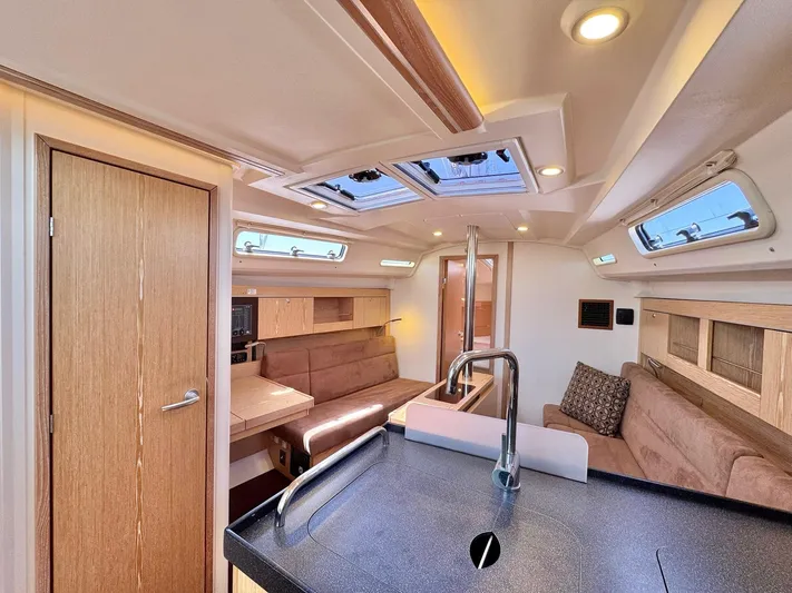 Ahyoka Yacht Photos Pics Interior of 2017 Hanse 345 yacht with modern kitchen and cozy seating area.