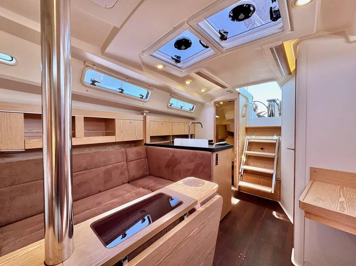 Ahyoka Yacht Photos Pics Interior of 2017 Hanse 345 yacht with modern wood finish and skylights.