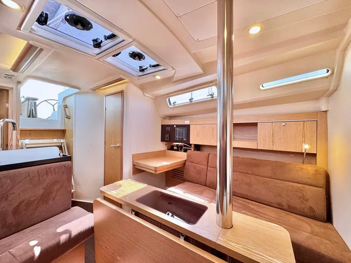 Ahyoka Yacht Photos Pics Interior of 2017 Hanse 345 yacht, featuring modern wood finish and comfortable seating.