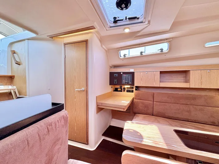 Ahyoka Yacht Photos Pics Interior of 2017 Hanse 345 yacht, featuring wooden cabinetry and seating area.