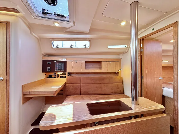 Ahyoka Yacht Photos Pics Interior of 2017 Hanse 345 yacht, featuring wooden furnishings and a cozy seating area.