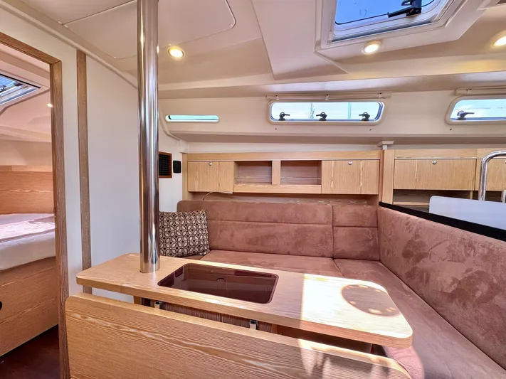 Ahyoka Yacht Photos Pics 2017 Hanse 345 yacht interior with cozy seating, wooden cabinetry, and natural light.