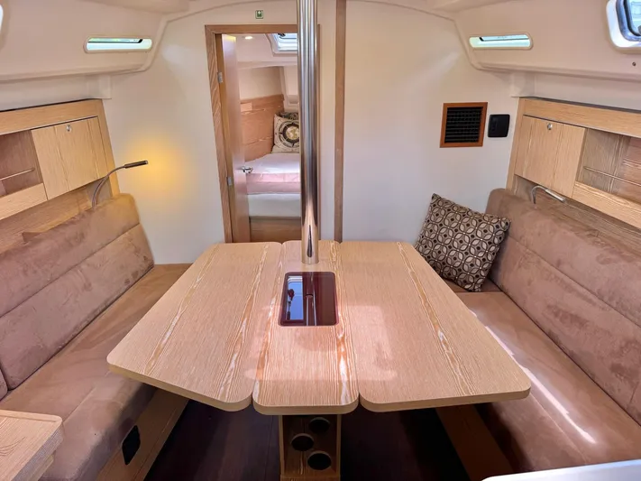 Ahyoka Yacht Photos Pics Interior of 2017 Hanse 345 yacht with cozy seating and wooden table.