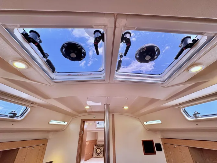 Ahyoka Yacht Photos Pics Interior view of 2017 Hanse 345 yacht with skylights and wooden cabinetry.