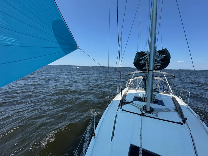 Ahyoka Yacht Photos Pics Sailing on a 2017 Hanse 345 yacht with blue spinnaker on open water.