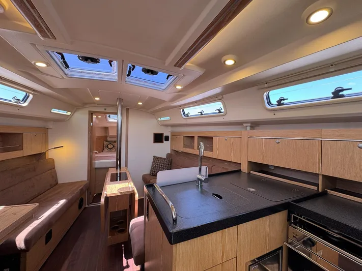 Ahyoka Yacht Photos Pics Interior of 2017 Hanse 345 yacht with modern kitchen and seating area.