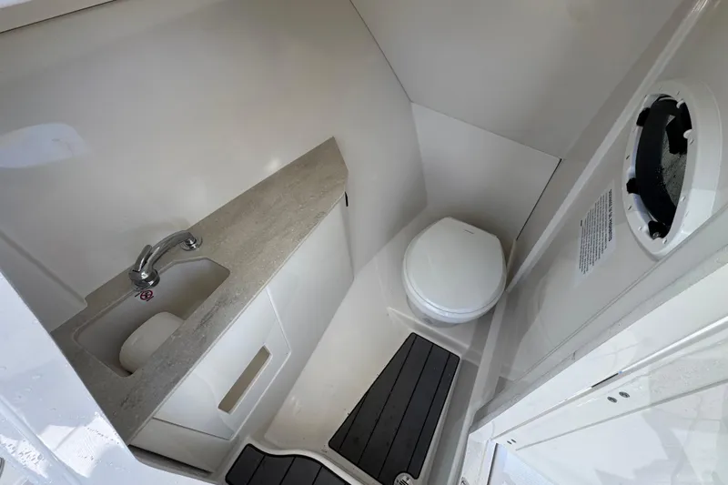  Yacht Photos Pics 2025 Sailfish 276 DC boat bathroom with sink, toilet, and compact design.